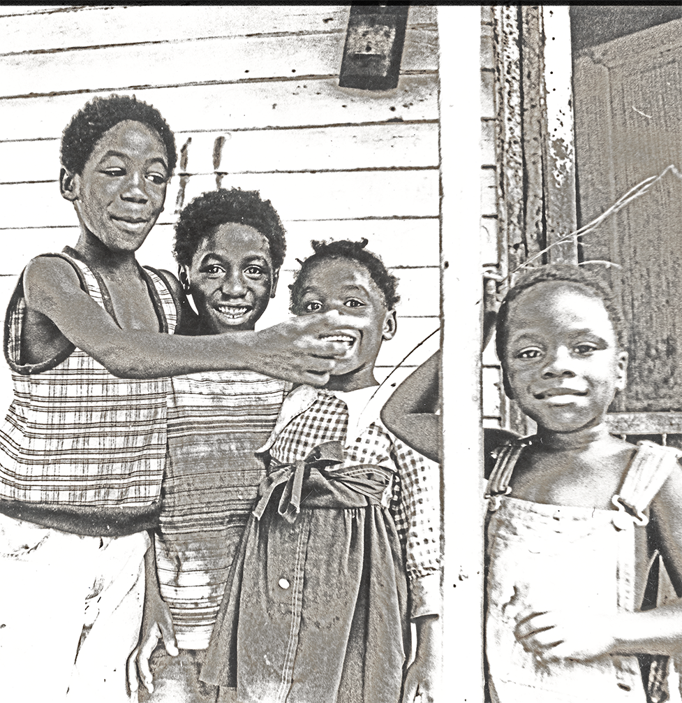 4 youngsters strike a pose on a front porch near the Mississippi River levy in Helena Arkansas in 1981