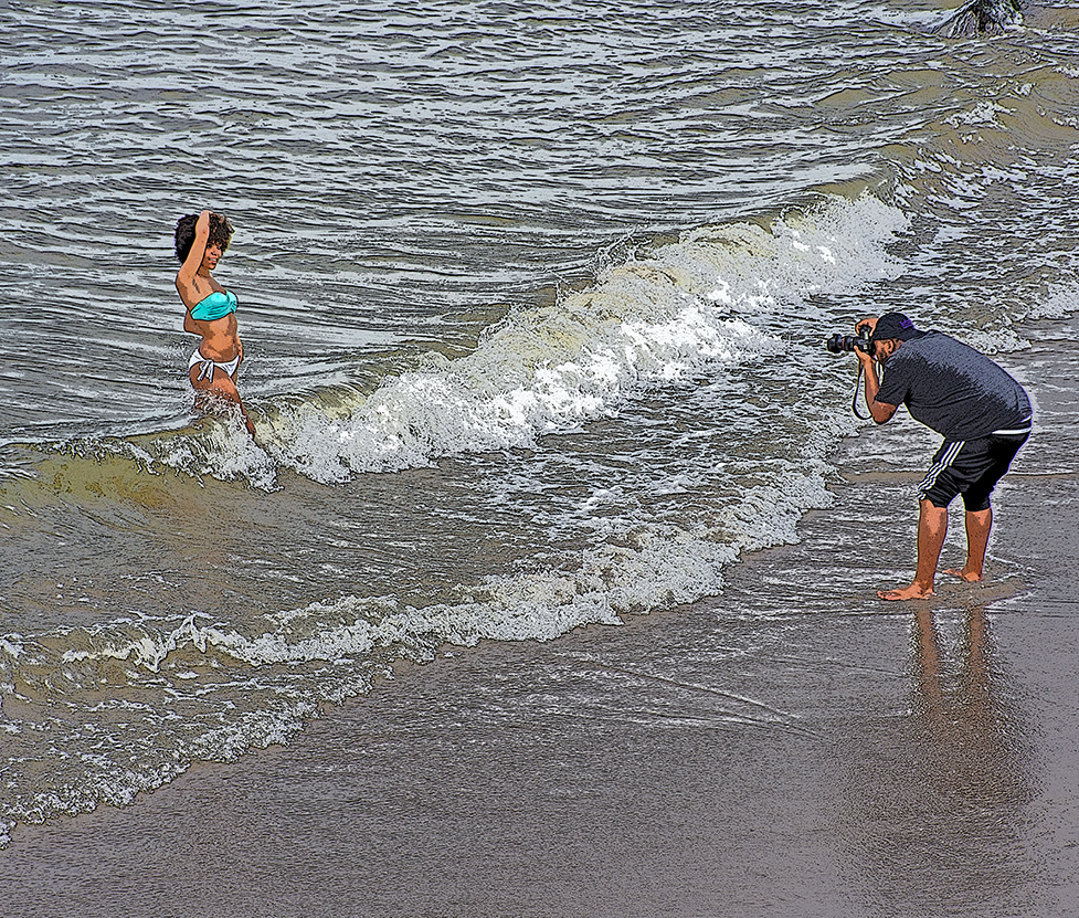 a woman poses for a photographer in the sea at Coney Island New York City on the afternoon of 11 August 2016