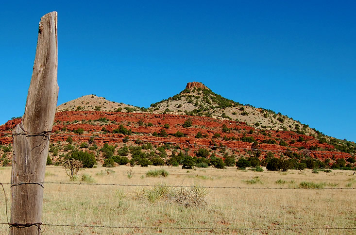 butte with fence post